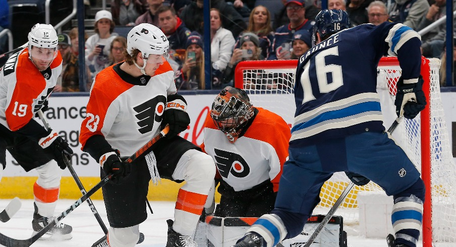 Philadelphia Flyers goalie Samuel Ersson (33) makes a save as Columbus Blue Jackets center Brendan Gaunce (16) looks for a rebound during the first period at Nationwide Arena.