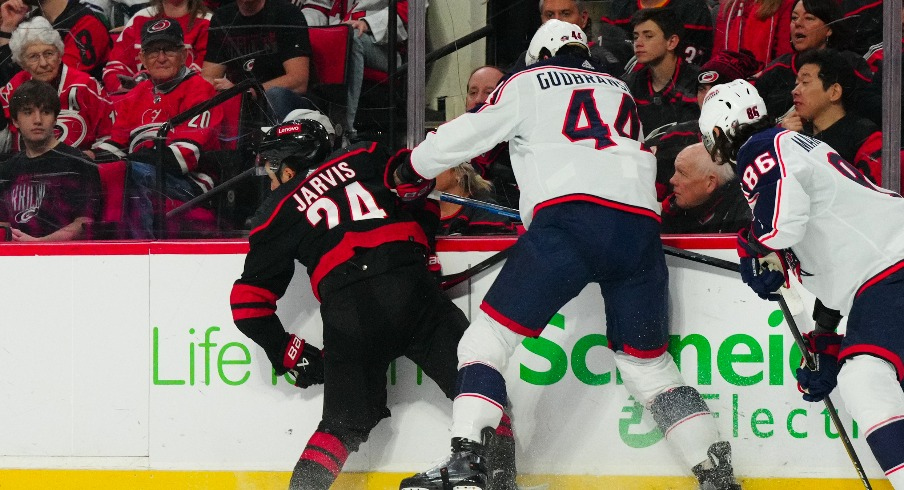 Columbus Blue Jackets defenseman Erik Gudbranson (44) checks Carolina Hurricanes center Seth Jarvis (24) during the first period at PNC Arena.