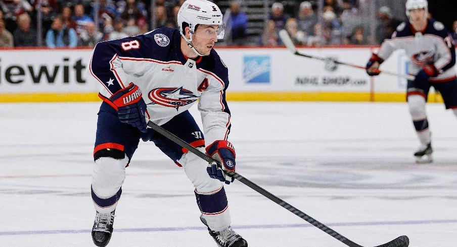 Columbus Blue Jackets defenseman Zach Werenski (8) controls the puck in the third period against the Colorado Avalanche at Ball Arena.