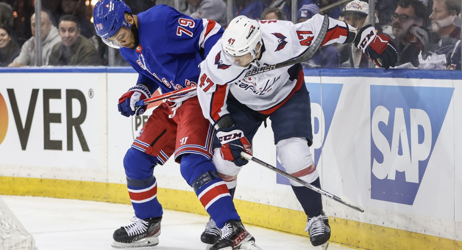 New York Rangers defenseman K'Andre Miller and Washington Capitals left wing Beck Malenstyn battle for control of the puck in game one of the first round of the 2024 Stanley Cup Playoffs