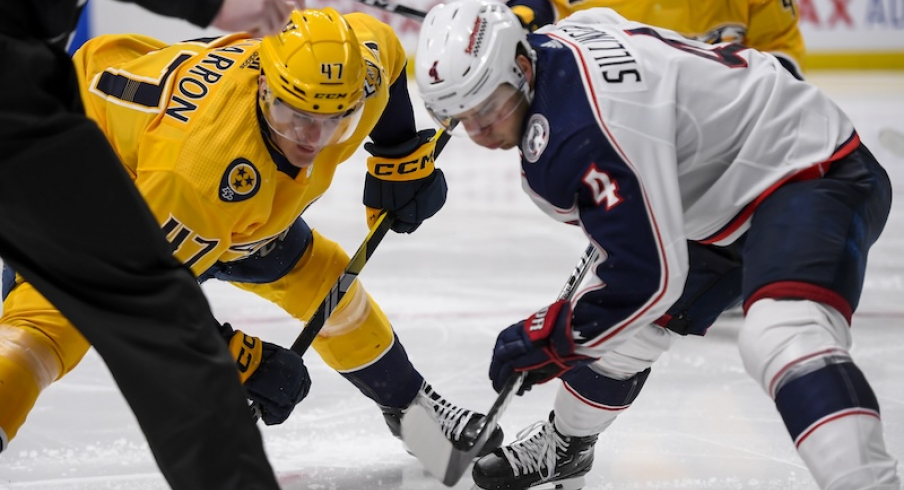 Nashville Predators right wing Michael McCarron (47) and Columbus Blue Jackets center Cole Sillinger (4) face off during the third period at Bridgestone Arena.