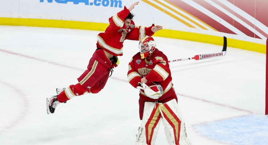 Denver Pioneers defenseman Zeev Buium (28) and goaltender Matt Davis (35) celebrate their teams win against the Boston College Eagles after the championship game of the 2024 Frozen Four college ice hockey tournament at Xcel Energy Center.