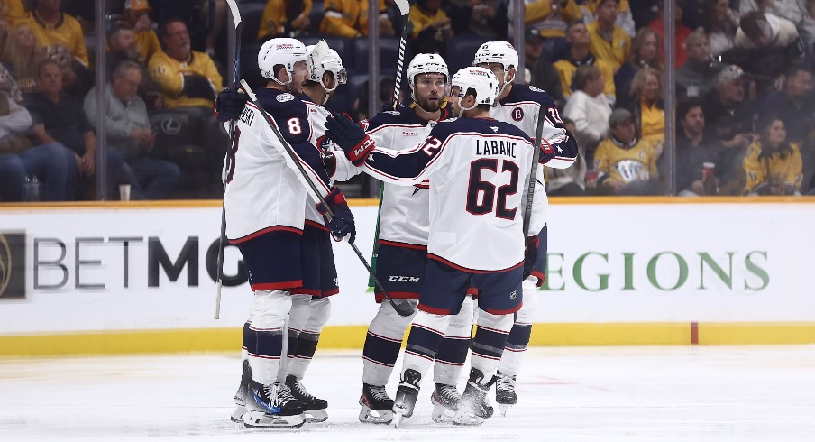 The Columbus Blue Jackets celebrate a goal by defenseman Zach Werenski (8) in the third period against the Nashville Predators at Bridgestone Arena.