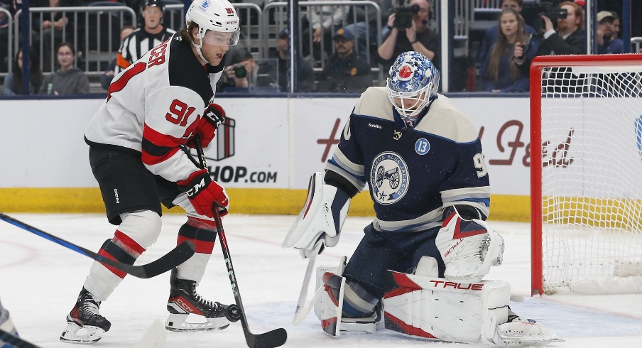 New Jersey Devils center Dawson Mercer (91) looks for a rebound of a Columbus Blue Jackets goalie Elvis Merzlikins (90) pad save during the first period at Nationwide Arena.
