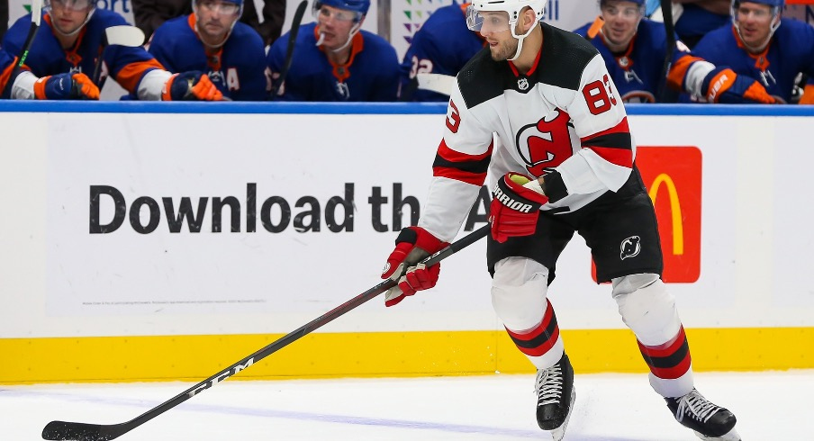 New Jersey Devils defenseman Christian Jaros (83) controls the puck against New York Islanders during the third period at UBS Arena.