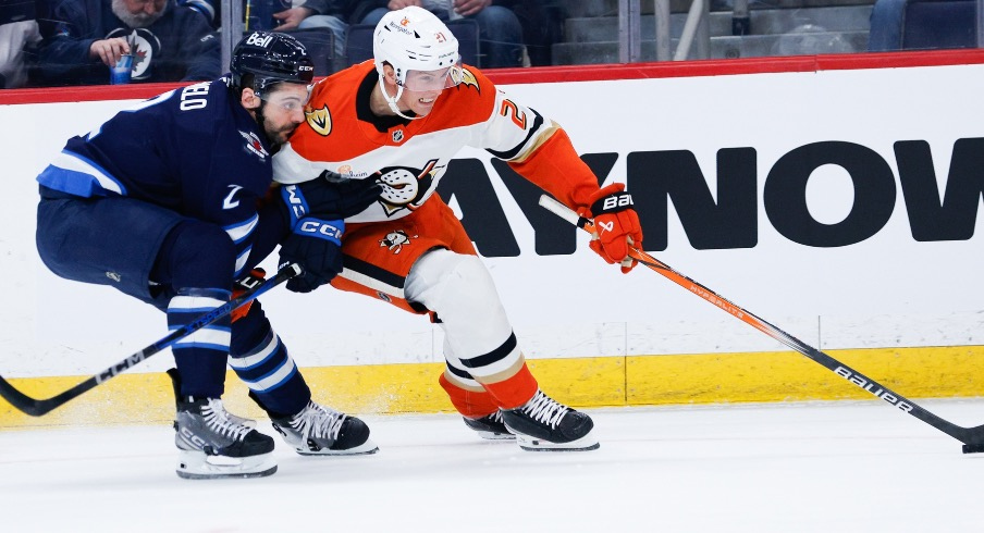 Anaheim Ducks forward Isac Lundestrom (21) tries to skate away from Winnipeg Jets defenseman Dylan DeMelo (2) during the first period at Canada Life Centre.