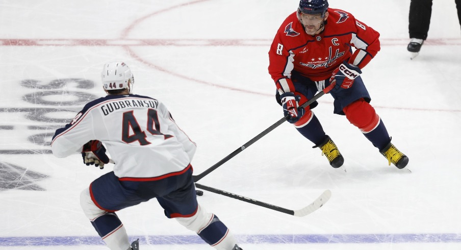 Washington Capitals left wing Alex Ovechkin (8) skates with the puck as Columbus Blue Jackets defenseman Erik Gudbranson (44) defends in the third period at Capital One Arena.