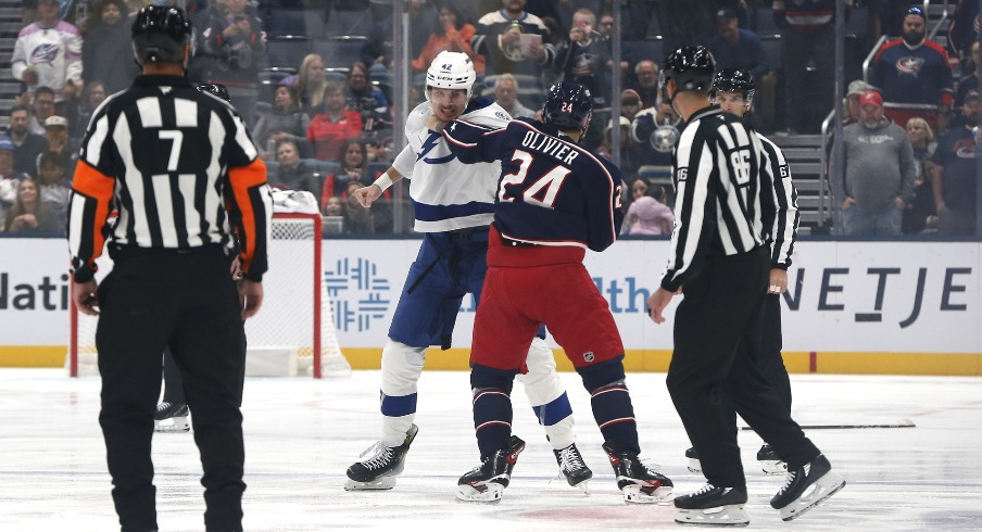 Oct 18, 2025; Columbus, Ohio, USA; Tampa Bay Lightning center Curtis Douglas (42) and Columbus Blue Jackets center Mathieu Olivier (24) fight during the first period at Nationwide Arena.