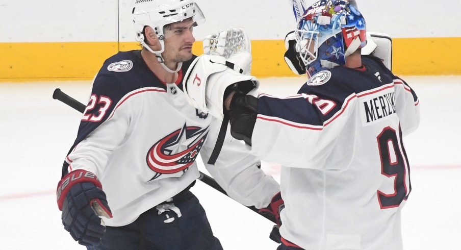 Oct 25, 2025; Pittsburgh, Pennsylvania, USA; Columbus Blue Jackets goalie Elvis Merzlikins (90) celebrates a win over the Pittsburgh Penguins with center Sean Monahan (23) after a shoot-out at PPG Paints Arena. The Blue Jackets won 5-4.
