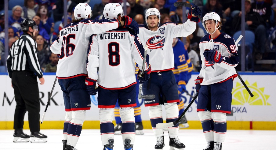 Oct 28, 2025; Buffalo, New York, USA; Columbus Blue Jackets defenseman Zach Werenski (8) celebrates his goal with teammates during the second period against the Buffalo Sabres at KeyBank Center.