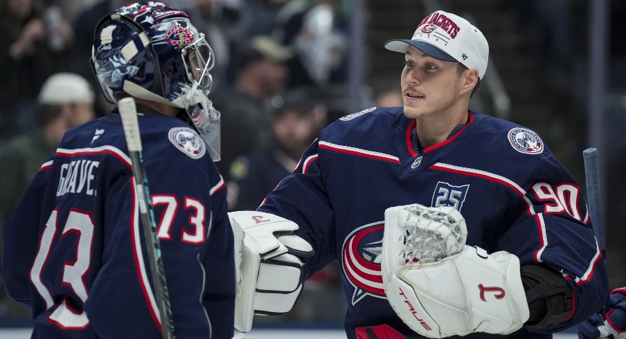 Nov 1, 2025; Columbus, Ohio, USA; Columbus Blue Jackets goaltender Jet Greaves (73) celebrates with goaltender Elvis Merzlikins (90) after defeating the St. Louis Blues at Nationwide Arena.