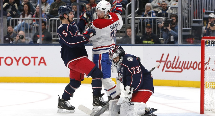 Nov 17, 2025; Columbus, Ohio, USA; Columbus Blue Jackets goalie Jet Greaves (73) makes a save as Montreal Canadiens center Jake Evans (71) looks for a rebound during the first period at Nationwide Arena.